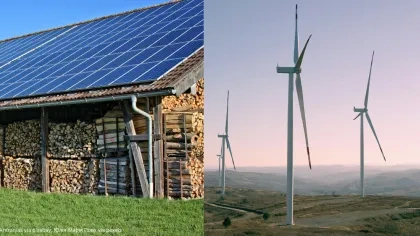 Solaranlage auf Hausdach und Winräder in der Landschaft